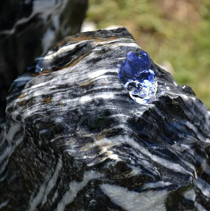 Close-up of wet Black Angel marble with a striking white mineral vein