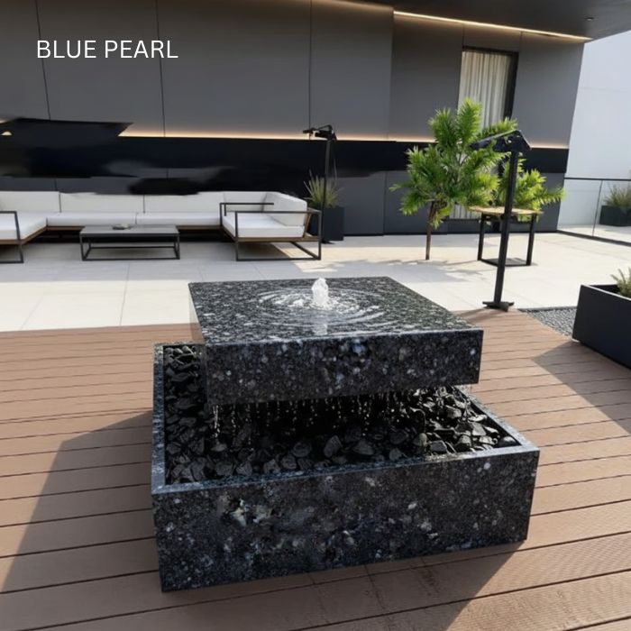 Quad designer fountain with a freestanding natural stone basin on a paved patio